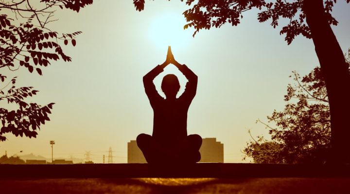 A person practicing yoga or meditation in a serene environment.